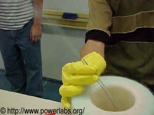  Rubber tube immersed in liquid nitrogen. The smoke being shot out is resultant of liquid nitrogen vaporising inside the tube and creating pressure.